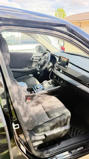 Front interior of the Mitsubishi Outlander, showing the driver's seat and dashboard
